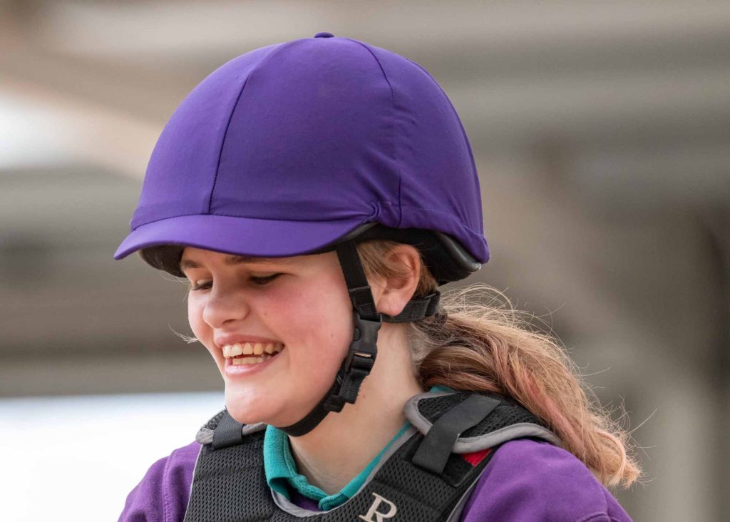 Volunteer riding a horse